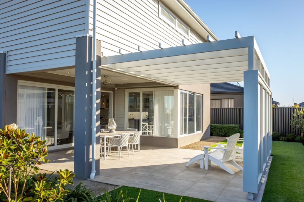 a patio with chairs and tables in front of a house representing real estate copywriting